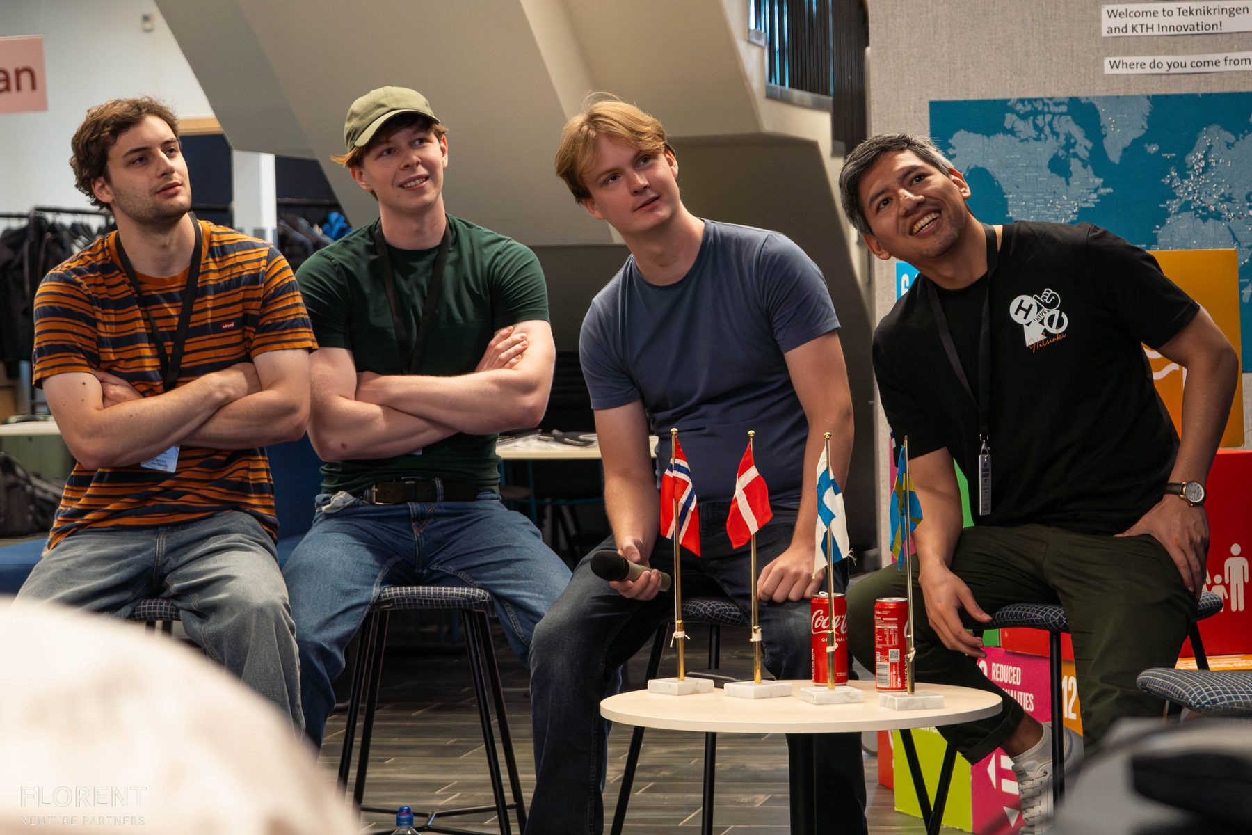 Four finalists watching a match, with Nordic flags on the table